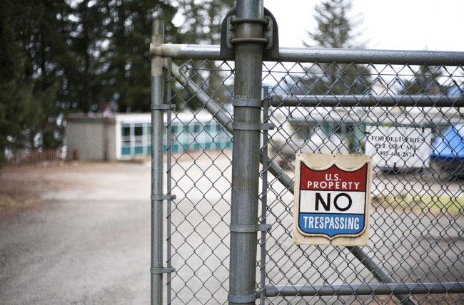 A chain-link fence cordons off the entrance to the Auke Bay Marine Station on Tuesday, Jan. 31, 2017. Juneau Docks and Harbors is interested in the NOAA property for potential expansion of Statter Harbor. (Photo Tripp J Crouse/KTOO)