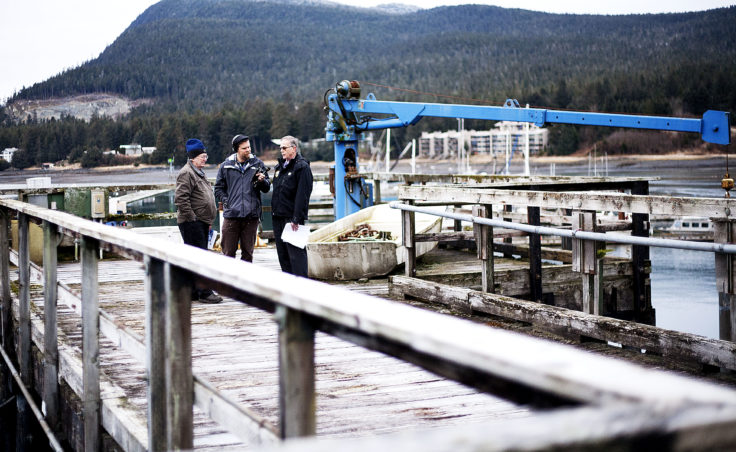 Juneau Docks and Harbors port engineer Gary Gillette listens as KTOO reporter Jacob Resneck interviews port director Carl Uchytil about the city's proposed expansion of Statter Harbor at the Auke Bay Marine Station property on Tuesday, Jan. 31, 2017. (Photo by Tripp J Crouse/KTOO)