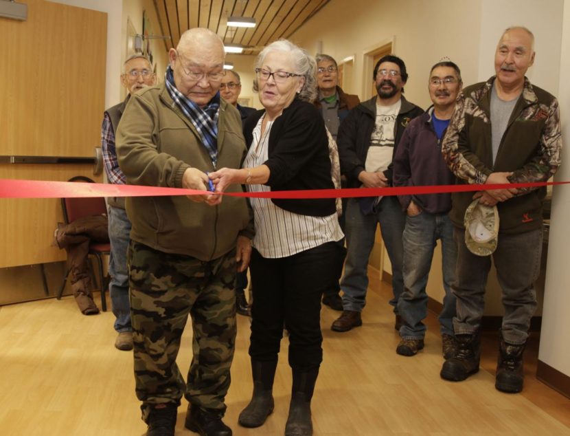 James Charlie Sr., YKHC Honorary Board Member, and Gloria Simeon, YKHC Board Vice Chair, perform the ribbon cutting ceremony at the opening of the Yukon Kuskokwim Ayagnirvik Healing Center on January 11, 2017, surrounded by YKHC board members.
