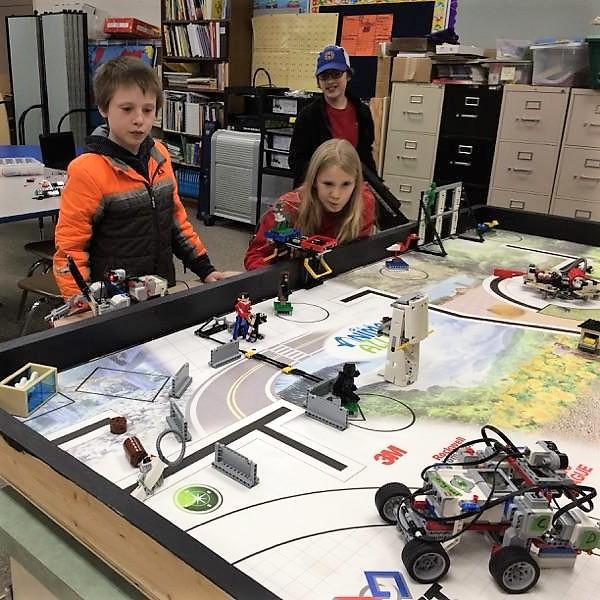 As part of the competition, the middle-schoolers program their Lego robot to perform a series of missions on a tabletop arena. (Photo courtesy of Marj Dunn)