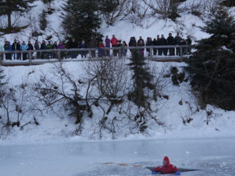 A member of the CCFR water rescue team voluntarily went into the icy water to demonstrate how to escape.