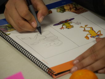 A high school student sketches a form line frog based on the main character from the Orange Frog comic book.