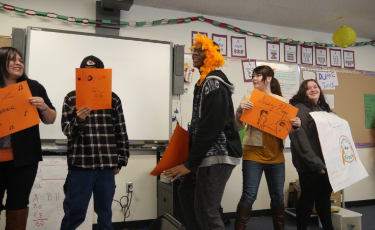 High School students and their teacher dance during an assigned presentation in the Orange Frog training.