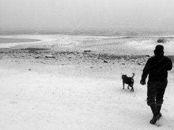 James Brooks walks his dog Cookie along Mendenhall Lake on Dec. 3, 2016, in Juneau.