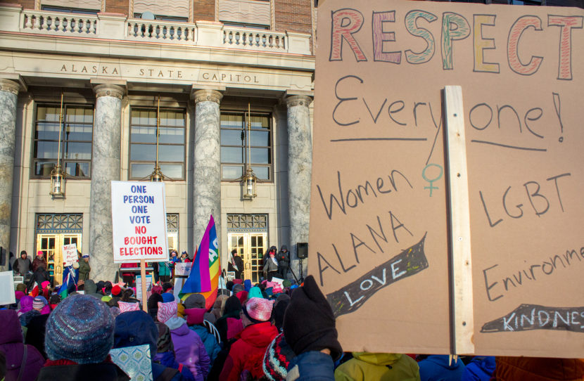Protesters wave signs at the Alaska State Capitol for the Women's March on Saturday January 21st, 2017 in Juneau. (Photo by Mikko Wilson/KTOO)