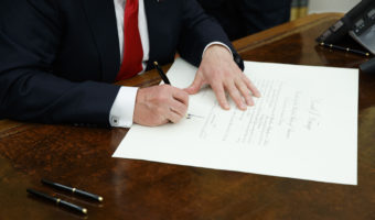 President Trump signs a confirmation for James Mattis to be defense secretary, Friday in the Oval Office. Evan Vucci/AP