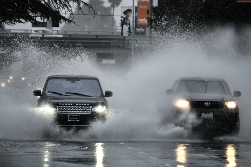 A flooded street in the Van Nuys section of Los Angeles on Sunday. Some California residents evacuated neighborhoods below hillsides scarred by wildfires, amid concerns about mudslides. (Photo by Richard Vogel/AP)