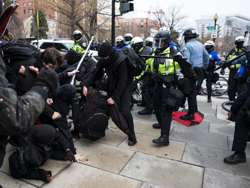 Police officers push a group of demonstrators back in Northwest Washington, D.C., on Friday. Violence broke out in the area among a crowd of several hundred, but the city's interim police chief says protests across the city have been largely peaceful. Zach Gibson/AFP/Getty Images