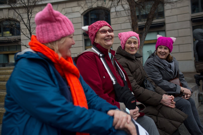 (Left to right) Melissa Breen, Laura Jamison, Sandy Cuza and Kathryn Wehrmann chat while sporting matching pink hats in support of the march. Becky Harlan/NPR