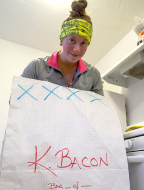 Tara Cicatello holds a drop bag she’s helping prepare for Kristin Bacon. (Photo by Zachariah Hughes/Alaska Public Media)