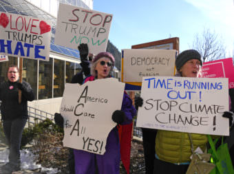 Protesters take part in a rally on Feb. 24, 2017, in front of the Alaska Capitol to encourage U.S. Sen. Dan Sullivan to hold a town meeting. Sullivan was at the Capitol earlier in the day to give his annual address to the Alaska Legislature. (Photo by Skip Gray/360 North)