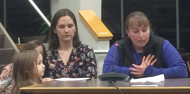 Two women with the Mendenhall River Community School Parent Teacher Organization speak to the school board during the budget meeting.