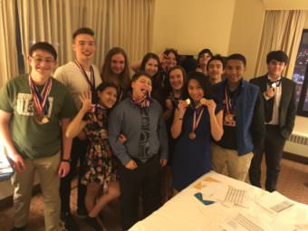 The JDHS academic decathlon teams pose with their medals.