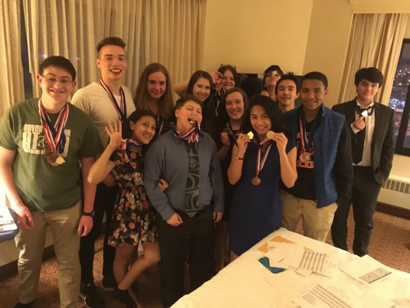 The JDHS academic decathlon teams pose with their medals.