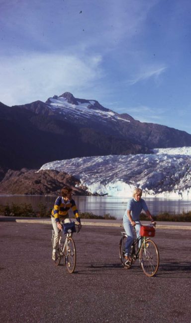 Mike and Marilyn Miller on bicycles in front of the Mendenhall Glacier in this 1975 photo.