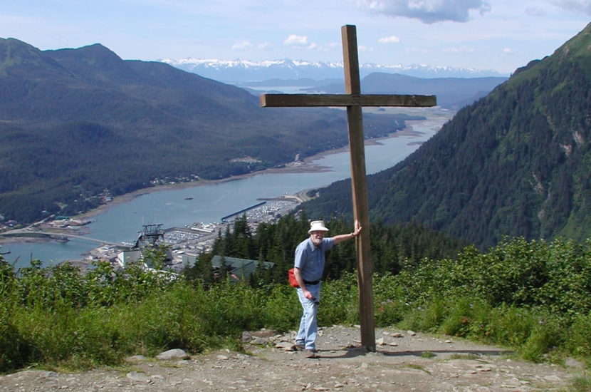 Mike Miller stands next to Father Brown's Cross in this 2001 photo.