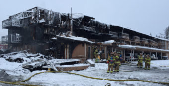 Firefighters put out the smoldering blaze at Royal Suites Lodge in midtown Anchorage on Feb. 15, 2017. (Photo by Anne Hillman/Alaska Public Media)