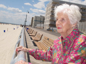 In this 2015 photograph, Lucille Horn stands on the boardwalk outside her home in Long Beach, N.Y.