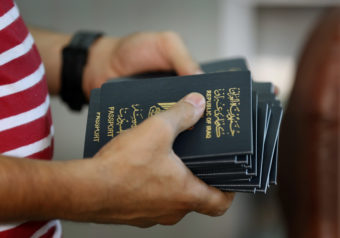 An employee delivers new passports at the main Baghdad Passport office in the Iraqi capital in 2015.