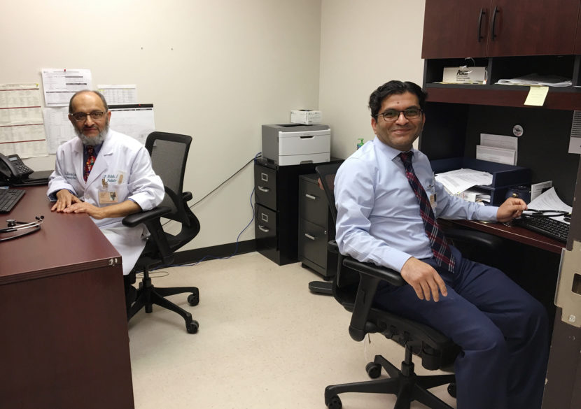Dr. Farooq Habib (left) and Dr. Muhammad Tauseef share an office at Los Barrios Unidos Community Clinic in Dallas. They're both from Pakistan and have both worked as pediatricians in medically underserved areas in the U.S. Lauren Silverman/KERA
