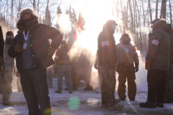 Fairbanks volunteers prepare for race start on banks of Chena River (Photo by Ben Matheson/KNOM)