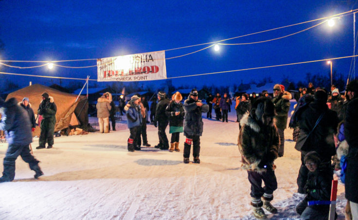 Huslia residents came out in force to welcome the first musher, Mitch Seavey, on Thursday night, March 9, 2017, during the Iditarod. (Photo by Ben Matheson/KNOM)