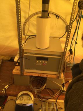 The beta attenuation monitor, or BAM, sits inside a heated tent. The unit draws in outside air through a stack that extends through the tent ceiling.
