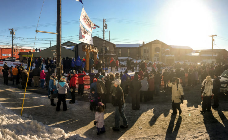 Race fans gathered at Nome’s Burled Arch to see Dallas Seavey and Nicolas Petit arrive Tuesday, March 14, 2017, during the Iditarod. (Photo by Ben Matheson/KNOM)