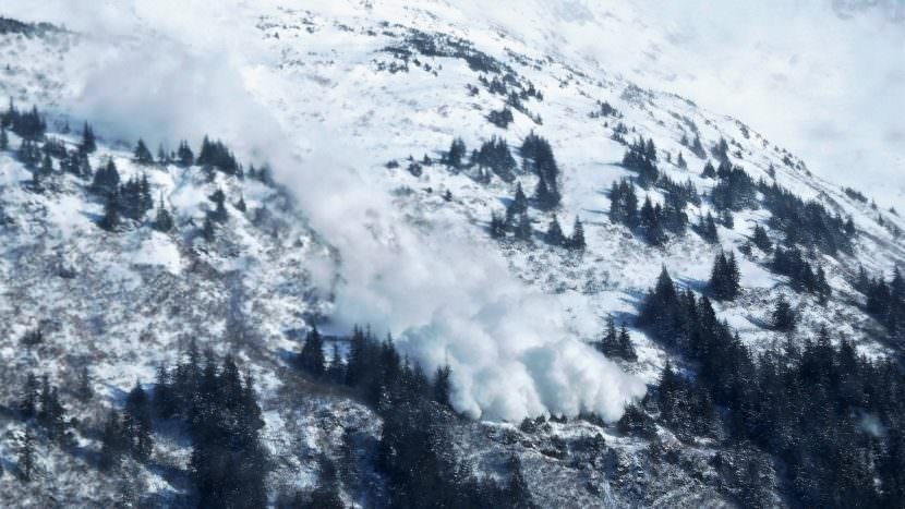 An avalanche triggered by a state crew slides down the slopes of Mount Roberts above Thane Road on March 3, 2017. The cloud of snow crossed the channel to Douglas. (Photo by Ed Schoenfeld, CoastAlaska News)