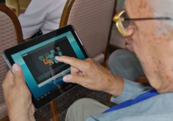 An elderly person uses a tablet. (Photo by Sigismund von Dobschütz/Wikimedia Commons)