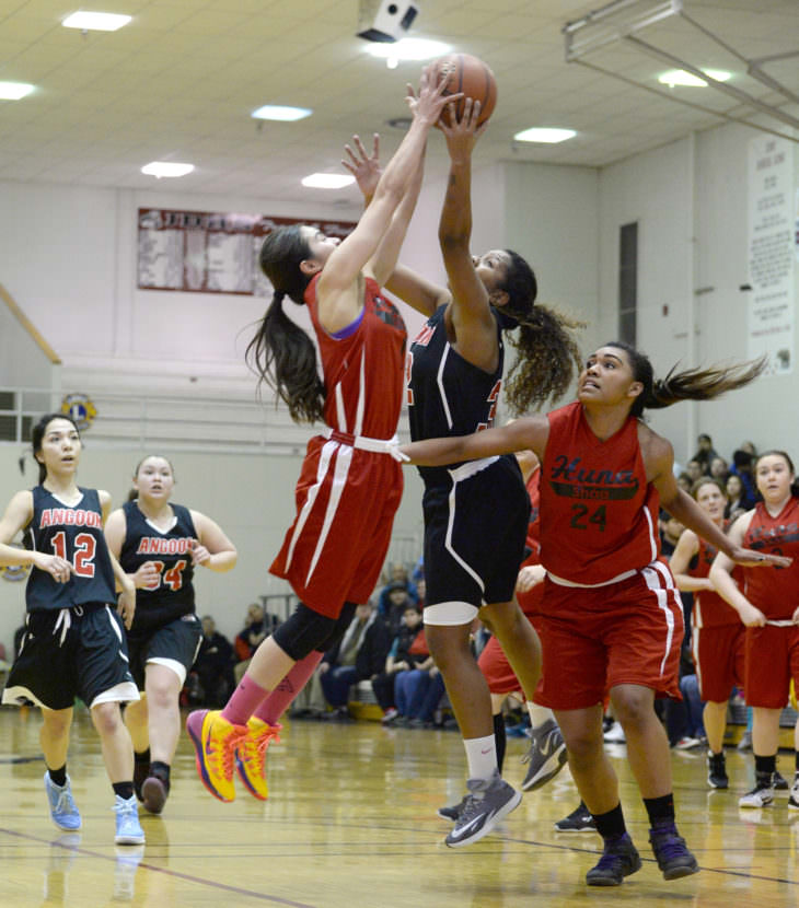 Hoonah’s Melissa Fisher and Taryn White (24) challenge a shot by Angoon’s Tasha McCoy during their elimination game in the 2015 Juneau Lions Club Gold Medal Basketball Tournament.