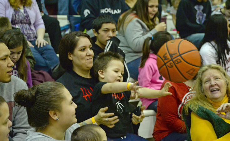 Basketball fan Kamari Lafferty, 2, returns a ball into play during the 69th Annual Gold Medal Basketball Tournament. (Photo courtesy Klas Stolpe)