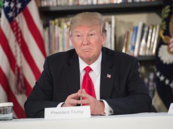 President Donald Trump looks on as he meets with parents and teachers at Saint Andrew Catholic School in Orlando, Fla., on March 3. Nicholas Kamm/AFP/Getty Images