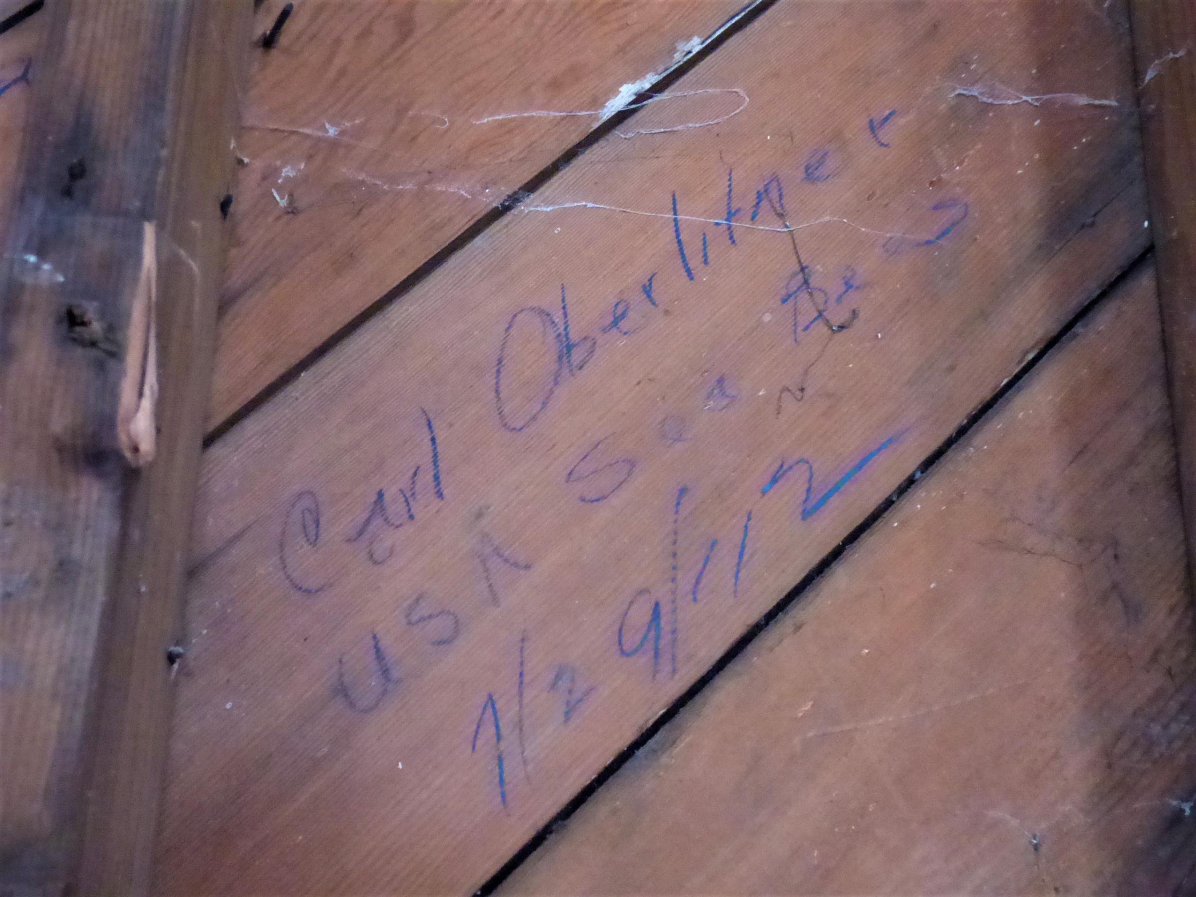 In another World War II building nearby, construction crews found this signature – “Carl Oberlitner, USA Seabee, 7/29/42” – behind mold and drywall. (Photo by Laura Kraegel/KUCB)