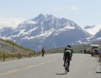 A solo rider crests the summit during the 2016 Kluane-Chilkat International Bike Relay. (Photo by Jillian Rogers/KHNS)