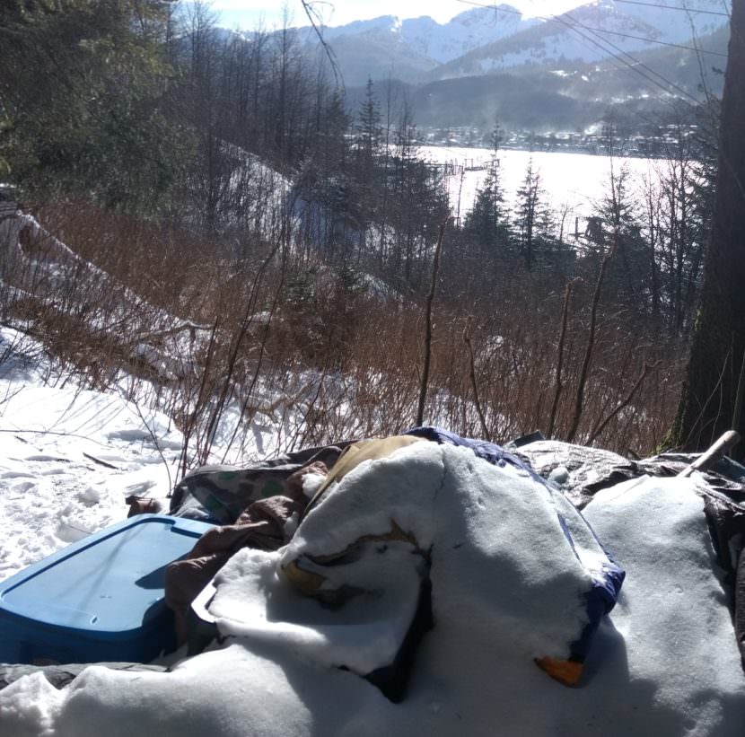 Snow collects on abandoned belongings at a campsite above downtown Juneau on March 3, 2017. AJT Mining Properties evicted its occupants in February. Homeless people have few legal camping options in the winter. (Photo Jacob Resneck/KTOO)