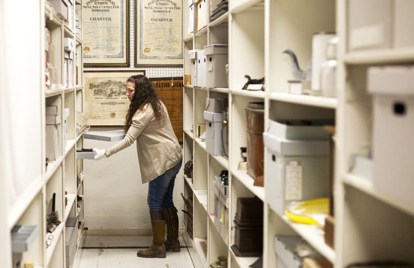 Jodi DeBruyne, curator of collections and exhibits for Juneau-Douglas City Museum, pulls items from the museums collections on April 14, 2017. (Photo by Tripp J Crouse/KTOO)