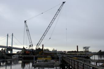 Turnagain’s Brightwater barge and crane at work on the Petro Marine fuel dock last winter. The same equipment will be used to build the dock at the Gary Paxton Industrial Park — unless the court rules the contract illegal.