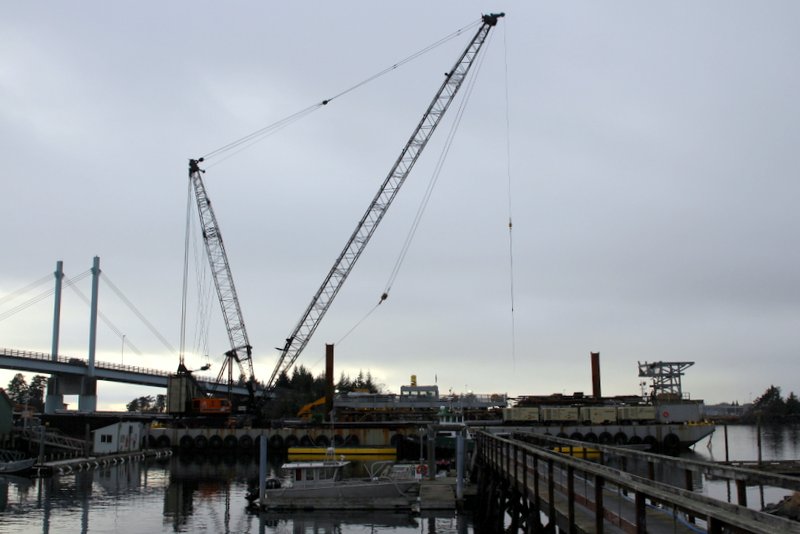 Turnagain’s Brightwater barge and crane at work on the Petro Marine fuel dock last winter. The same equipment will be used to build the dock at the Gary Paxton Industrial Park — unless the court rules the contract illegal.