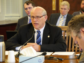 Sen. John Coghill, R- North Pole, testifies before the Senate Finance Committee in favor of SB 48, a bill he sponsored that would give medical insurance premiums for surviving dependents of certain peace officers or firefighters who die in the line of duty, April 5, 2017. (Photo by Skip Gray/360 North)
