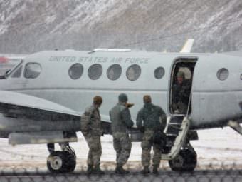 Explosive specialists with the U.S. Air Force return to their plane Tuesday after destroying World War II-era ordnance found in Unalaska. (Photo by Laura Kraegel/KUCB)