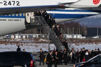 Members of the Chinese media and other passengers deplane from President Xi Jinping’s plane. (Photo by Wesley Early, Alaska Public Media – Anchorage)