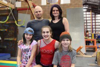 The Kronos gym is a family affair. Cody Johnston owns it with his wife, Tara. Their three children, Riley, 15, and 12-year-old twins Chase and Preslie, help with classes. (Photo Emily Kwong/KCAW)
