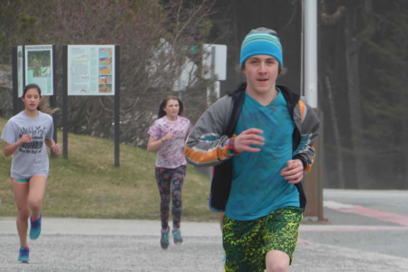 Eight-Grader Sage Yeshua runs a timed mile around the Dzantik'i Heeni Middle School parking lot.