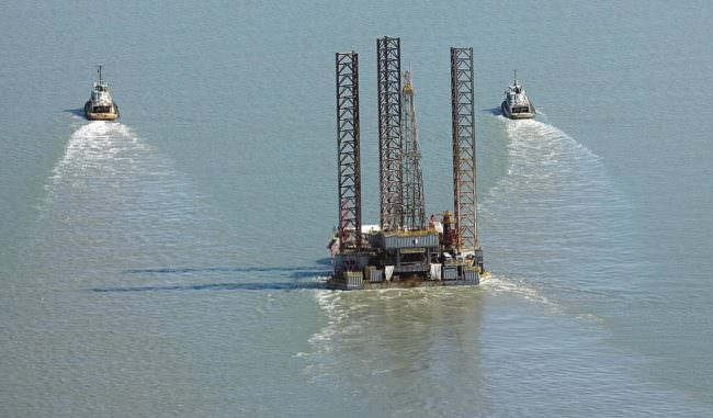 Tugs pull the Spartan 151 jack-up drilling platform up Cook Inlet in August 2011. Furie Operating Alaska, formerly Escopeta Oil, expects to be drilling again in the spring. (Photo courtesy Peninsula Clarion)