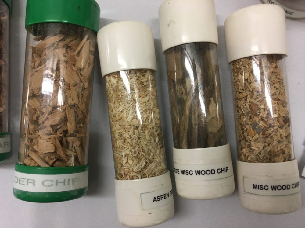 Different wood chips are displayed at the 2017 Alaska Wood Energy Conference at Ketchikan’s Ted Ferry Civic Center. (Photo by Leila Kheiry/KRBD)