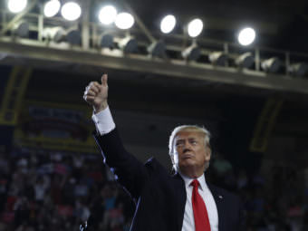 President Donald Trump gives a thumbs-up to the audience behind him as he finishes speaking in Harrisburg, Pa., on Saturday.