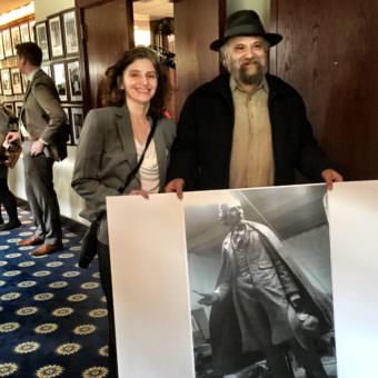 Judith Rubin and her brother, David, show a poster of their statue at a luncheon at the National Press Club. (Photos by Liz Ruskin/Alaska Public Media)