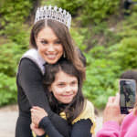 Miss Alaska USA Alyssa London poses with Juneau Community Charter School student Adrienne Whicker as her grandmother Alice Sollie takes their photo on Thursday, May 25, 2017, at Sandy Beach in Douglas.