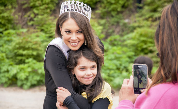 Miss Alaska USA Alyssa London poses with Juneau Community Charter School student Adrienne Whicker as her grandmother Alice Sollie takes their photo on Thursday, May 25, 2017, at Sandy Beach in Douglas.